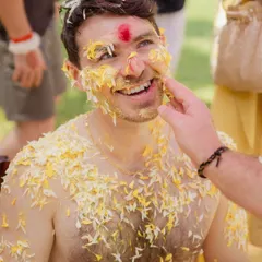 The groom's pure, unfiltered reaction during his Haldi ceremony. It's these candid smiles and playful moments that tell the real story of the day.