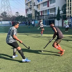 An intense face-off between two players during a Sunday morning practice. This is where skills are sharpened and competitive instincts are honed.