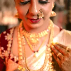A close-up of the bride, showcasing her intricate gold jewelry and flawless makeup. I focus on these details to highlight the beauty of the bridal look.
