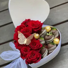 This heart shaped box is the perfect romantic gesture. One side is filled with fresh red roses, while the other has chocolate covered strawberries and Ferrero Rochers, accented with a golden butterfly.