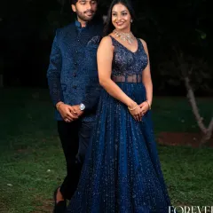 I love creating coordinated looks for couples. Here, the bride's dazzling blue katdana corset gown is perfectly complemented by the groom's matching textured bandhgala jacket. It's a sophisticated choice for an engagement party or evening reception.