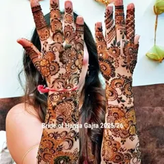 A happy bride showing off her full-coverage floral mehendi. The design is as vibrant and beautiful as her smile, perfect for her special day.