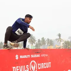 An obstacle course race is about explosive power and agility. This is me clearing a wall jump at the Maruti Suzuki Devil's Circuit. We practice these movements, focusing on technique and efficiency, so you can vault over walls without wasting energy.