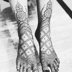 A black and white photo of this geometric leg design. The sharp lines of the checkerboard pattern and the floral cuff look so striking.