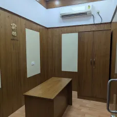The completed Vidhana Soudha office interior, showing the final execution of the design. The space features clean lines, wood finishes, and the official state emblem, reflecting a professional environment.