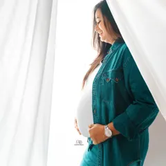 This relaxed portrait in a denim shirt and jeans shows a casual and comfortable side of maternity style. Perfect for an at-home or simple studio session.
