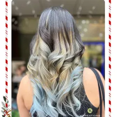 For those who dare to be different, we create bold, artistic color statements. This striking look features a platinum blonde fringe and icy blue ombre, showcasing our expertise in creative hair coloring.