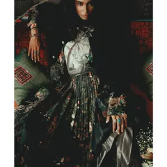 In this shot from 'Roots', the model is enveloped in layers of printed and textured fabrics. The styling is intentionally dense, representing the complex and interwoven nature of our heritage.