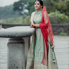 The contrast of her red dupatta adds a pop of color to this look. The makeup is kept subtle and glowing to let her natural beauty and stunning outfit shine.