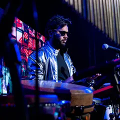 A moody shot from a performance at the IIMA Chaos festival. The lighting and my focus on the electronic pads highlight the modern, fusion aspect of my music.