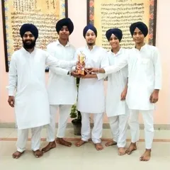 Our winning team proudly displays their trophy after securing first place in a prestigious kirtan competition.