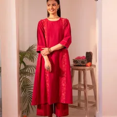 A full look at our red Haveli kurta set. The combination of the A-line kurta and matching pants, both adorned with Chikankari embroidery, creates a striking festive ensemble.
