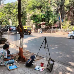 Here I am, engaged in plein air painting on a city sidewalk. This practice of painting outdoors is crucial for capturing the authentic light and atmosphere of a location.