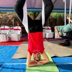 Another student enjoying an inversion during the Kerala workshop. The smile says it all; aerial yoga is as joyful as it is challenging.