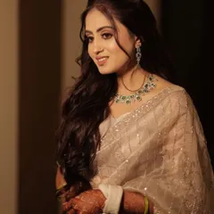 A candid moment of pure happiness. Her soft glam makeup, featuring a subtle shimmer on the eyes and a natural glow, looks beautiful in this softly lit portrait.