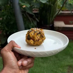 A single, beautifully presented Muttige, a pounded Jowar roti dish, representing a taste of home for me.