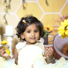 A sweet close-up from the sunflower and honeycomb themed photoshoot, capturing a gentle smile.