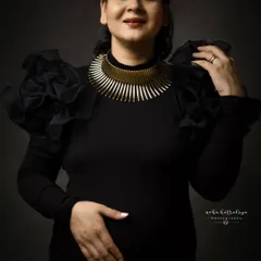 A closer look at the details. The ruffled sleeves and statement necklace were key parts of this powerful, self-styled look.