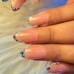 For a touch of sparkle, we created this beautiful design featuring a rainbow of tiny crystals lining the cuticle. It's a simple yet glamorous way to add color and shine to a neutral manicure.