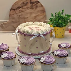 Here's the full view of the vintage "Bride to be" cake alongside matching dark chocolate and salted caramel cupcakes. A coordinated dessert spread makes any celebration feel extra special.