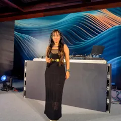 A full-length shot at a private party, showing how I coordinate my attire with the event's sophisticated black-tie feel. The setup included a large LED backdrop.