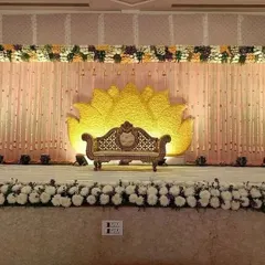 For a truly grand statement, I designed this reception stage with a massive lotus flower motif made entirely of yellow flowers. The stage is bordered with white and purple flowers, creating a stunning and unique backdrop for a large celebration.