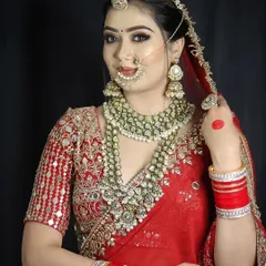 A close-up on the detailed jewelry and makeup of a traditional Indian bride. Our curriculum includes lessons on how to complement heavy bridal attire and jewelry with the right makeup.