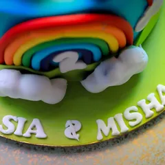 A close-up of the beautiful rainbow cake for Sia and Misha's second birthday. The detailed fondant work and vibrant colors made it a centerpiece of the celebration.
