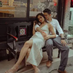 A stylish, urban pre-wedding shoot, with the couple sharing an intimate moment on a bench in the charming streets of a city market.