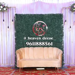 This modern reception stage combines a lush green foliage wall with sleek golden frames and hanging Edison bulbs. The design is both organic and industrial, offering a chic and trendy setting for your event.