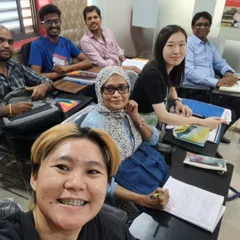 A candid selfie from one of our classes shows students from various walks of life learning together. This collaborative environment is key to building confidence and practicing language skills.