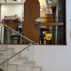 A custom-designed partition separating the dining space, featuring wood, metal, and hand-painted art panels.