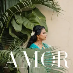 A bride framed by lush green leaves. This portrait uses nature to create a beautiful, organic composition that highlights her serene beauty on her engagement day.