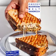 The ultimate cheese pull from my Cheesy Mushroom Melt Sandwich. It's loaded with a savoury mushroom-cheese mix and mint pesto on my signature seeded sourdough.