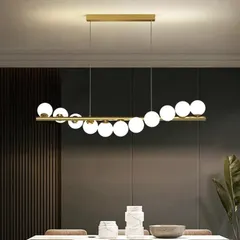 A beautiful view of our 11-ball chandelier, showcasing its elegant design and warm illumination. The golden finish and white glass spheres create a modern yet timeless look that enhances any dining or living space.