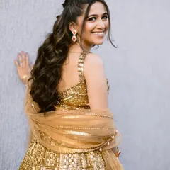 A playful shot from the Sangeet night. The makeup is glamorous and designed to catch the light as she dances, ensuring she sparkles from every angle.