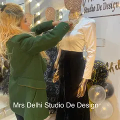 Here I am styling a mannequin in a chic, Bollywood-inspired outfit. The ensemble features a classic white long-sleeve top paired with a black velvet skirt and a statement gold neckpiece, a look that is both timeless and modern.