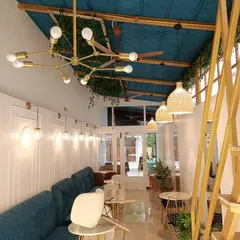 Lighting is crucial in setting the right mood. In this cafe, we layered multiple light sources, including a modern sputnik chandelier, woven pendant lamps, and classic wall sconces, to create a warm and dynamic ambience from day to night.