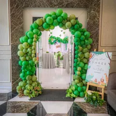 An arch of green balloons creates an exciting entrance, inviting little explorers to step into a wild jungle adventure. This setup at the doorway immediately sets the tone for a fun and immersive party experience.