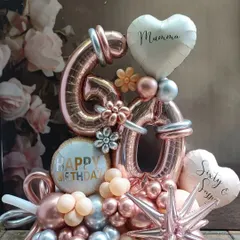 Celebrating 60 in style with this elegant rose gold and silver number bouquet. We personalized it with "Mummy" and "Sixty & Sassy" heart balloons to make it a truly special tribute for a milestone birthday.