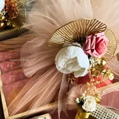 For me, trousseau packaging is an art. I combine elegant details like pastel net, artificial peonies and roses, and touches of gold to create a luxurious wrap for your wedding gifts that feels as special as the day itself.