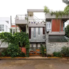 Our architecture embraces the environment around it. The exterior of this home integrates natural stone, wood paneling, and abundant greenery, allowing the structure to blend seamlessly with its surroundings and become a living part of the landscape.