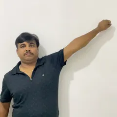 This image shows Mr. Hukum during his recovery, working on regaining overhead arm movement. Consistent, guided exercises are a key part of our treatment plans.