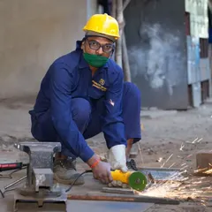 This action shot was taken during an industrial photography project at a manufacturing facility. Capturing the sparks from the angle grinder adds a dynamic element that documents the authentic, hands-on work happening on the factory floor.