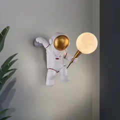 Bring a sense of wonder and exploration to a room with my astronaut wall light. The playful design features a spaceman holding a textured 'moon' globe that emits a soft, gentle light, perfect for a child's room or a creative study.