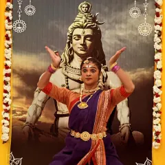 A powerful pose from a Shivratri stage performance, captured in full costume with a large image of Lord Shiva in the background. This shows the intensity and devotion I bring to my classical performances.