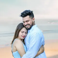 An intimate closeup from a beach pre-wedding shoot, focusing on the couple's happy and serene embrace.