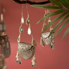 Not just a bag, but a statement of art. This silver, mirror-work clutch hangs like a piece of jewelry, with its cascading teardrop tassels catching the light.