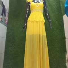 This glamorous yellow gown is perfect for a Haldi ceremony, cocktail party, or pre-wedding shoot. It features a delicate lace and pearl top with a sheer flowing skirt.
