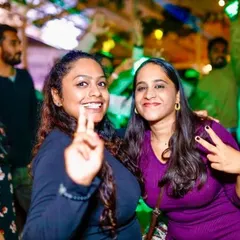 Guests flashing peace signs and enjoying the party. The positive energy of the crowd fuels my performance.